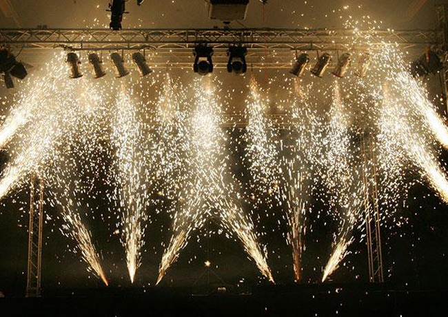 Cold spark fountains firing on a stage during an indoor corporate event