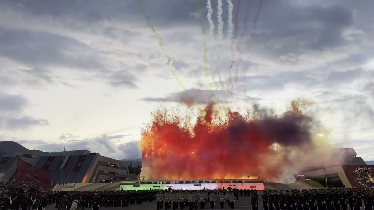 A large-scale red smoke curtain during an outdoor military ceremony
