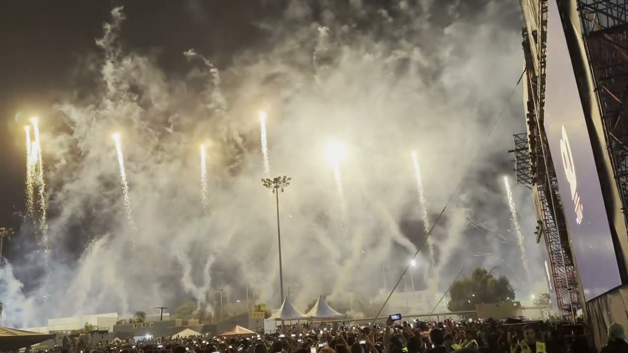 Large-caliber aerial pyrotechnics over a packed sports venue